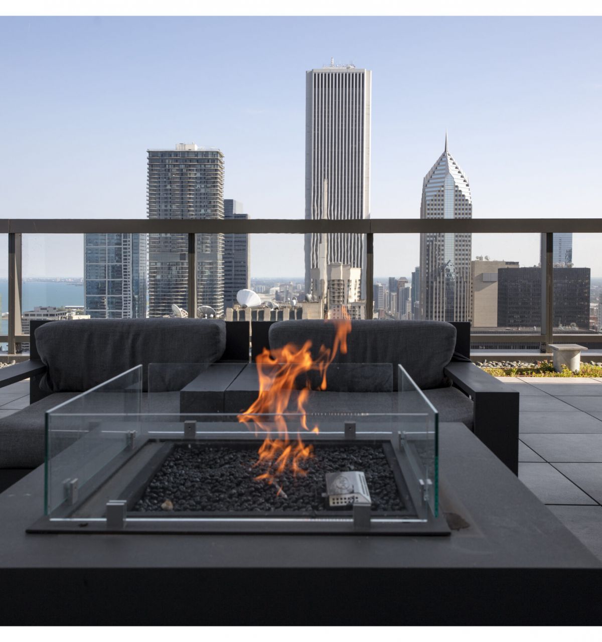 Optima Signature in Downtown Chicago with A modern rooftop patio at Optima Signature features a fire pit, chic seating, and views of Chicago’s luxury apartments and skyline.