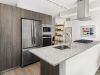 Optima Signature in Downtown Chicago with Modern kitchen with stainless steel appliances, wood cabinets, and a granite island—perfect for hosting at home.