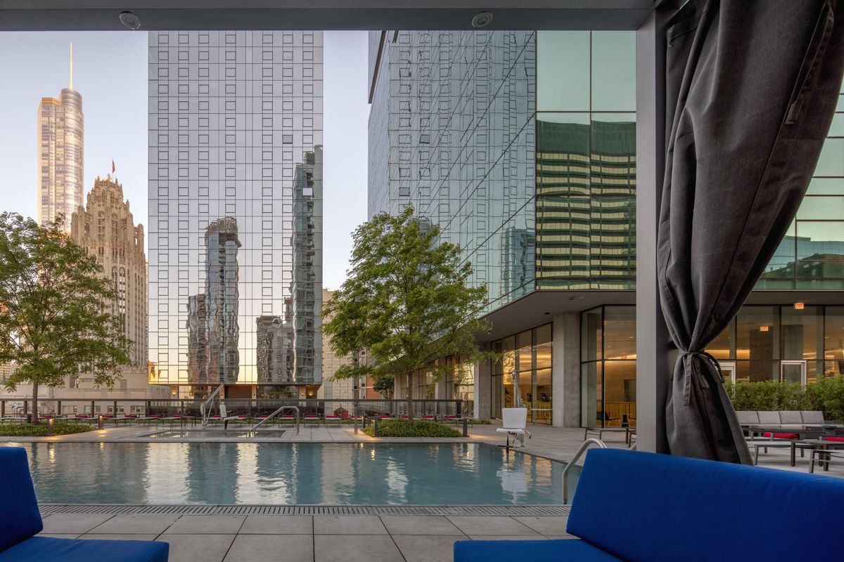 Optima Signature in Downtown Chicago with Modern city view from a poolside cabana at Optima Signature, offering year-round outdoor living and high-rise reflections in the water.