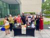 Optima Signature in Downtown Chicago with Members of the Optima Community enjoy daily life, smiling around a table with drinks outdoors.