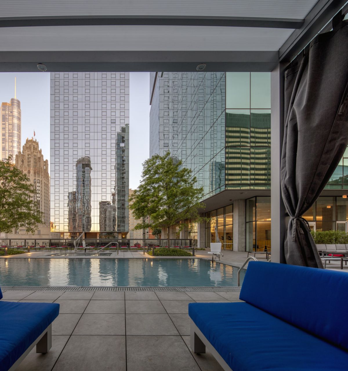 Optima Signature in Downtown Chicago with Modern city view from a poolside cabana at Optima Signature, offering year-round outdoor living and high-rise reflections in the water.
