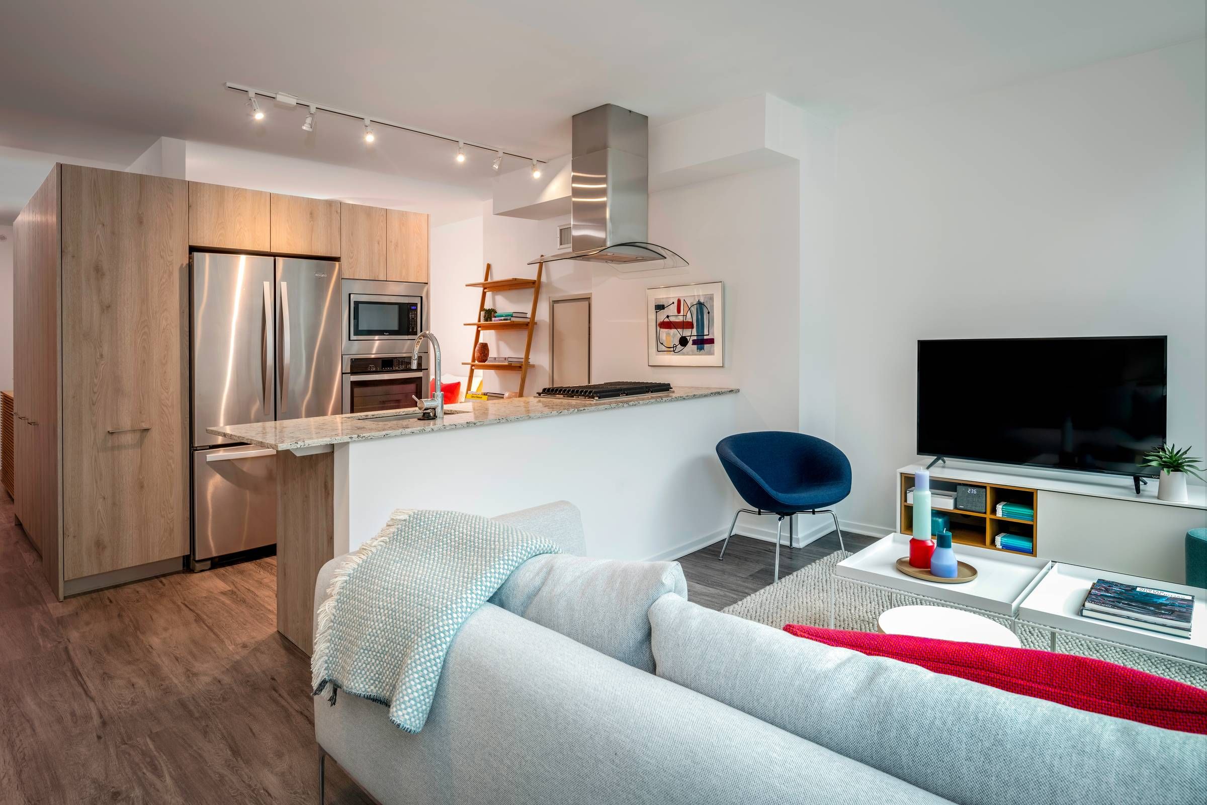 Optima Signature in Downtown Chicago with Modern open-plan kitchen and living room with stainless steel appliances and minimalist decor.