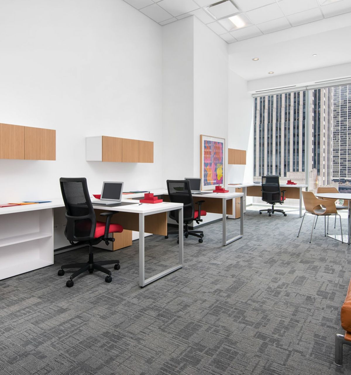 Optima Signature in Downtown Chicago with Modern office with desks, chairs, and city view through large windows; minimalist decor and natural light.