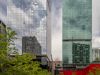 Optima Signature in Downtown Chicago with Two tall glass skyscrapers with reflections stand behind a green park, illustrating optimized service in an urban oasis under a partly cloudy sky.