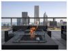 Optima Signature in Downtown Chicago with A rooftop patio at Optima Signature featuring a modern fire pit, lounge seating, and stunning city skyline views in the background.