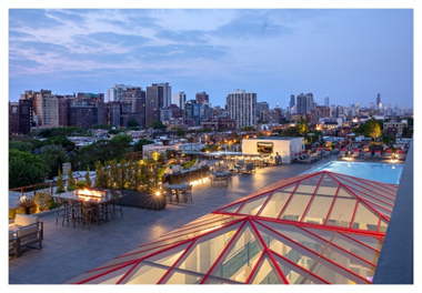Optima Signature in Downtown Chicago with Rooftop terrace with seating, fire pit, pool, and city views at dusk—enjoy premium rooftop amenities under a partly cloudy sky.