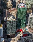 Optima Signature in Downtown Chicago with Aerial view of tall glass office buildings in a city with a small plaza and streets below.