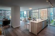Optima Signature in Downtown Chicago with Modern apartment with floor-to-ceiling windows, open kitchen, island seating, and city views.